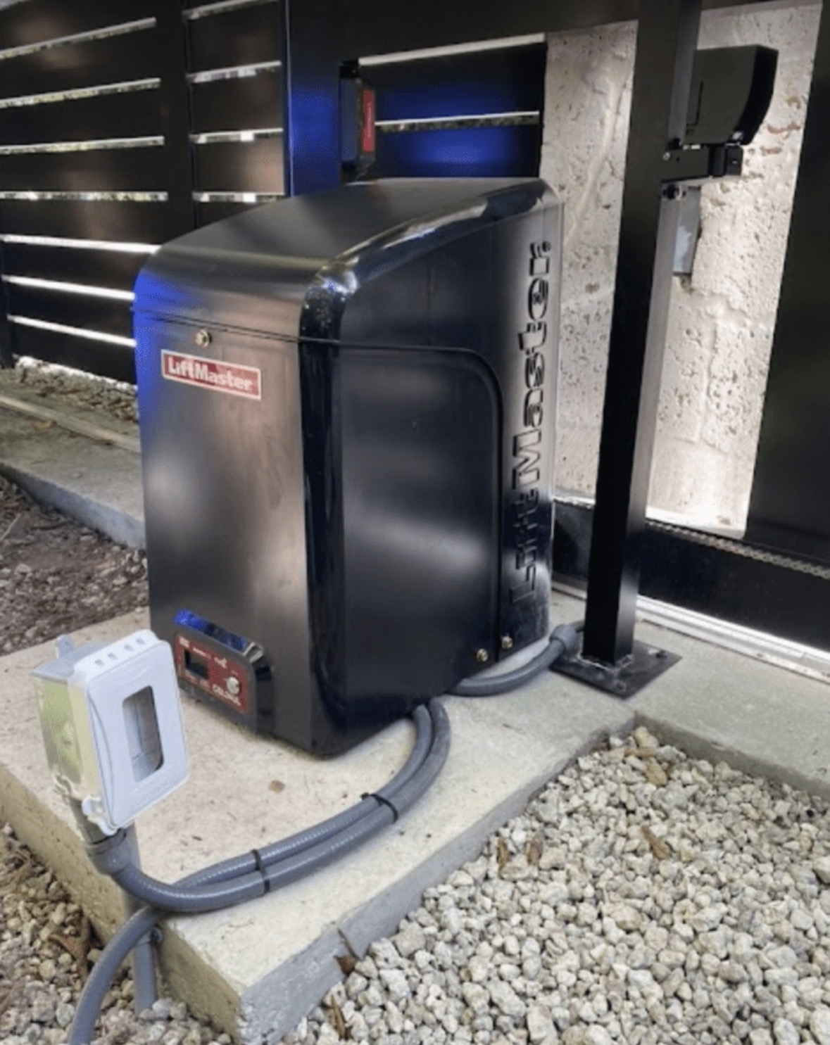 LiftMaster slide gate opener installed behind a fence