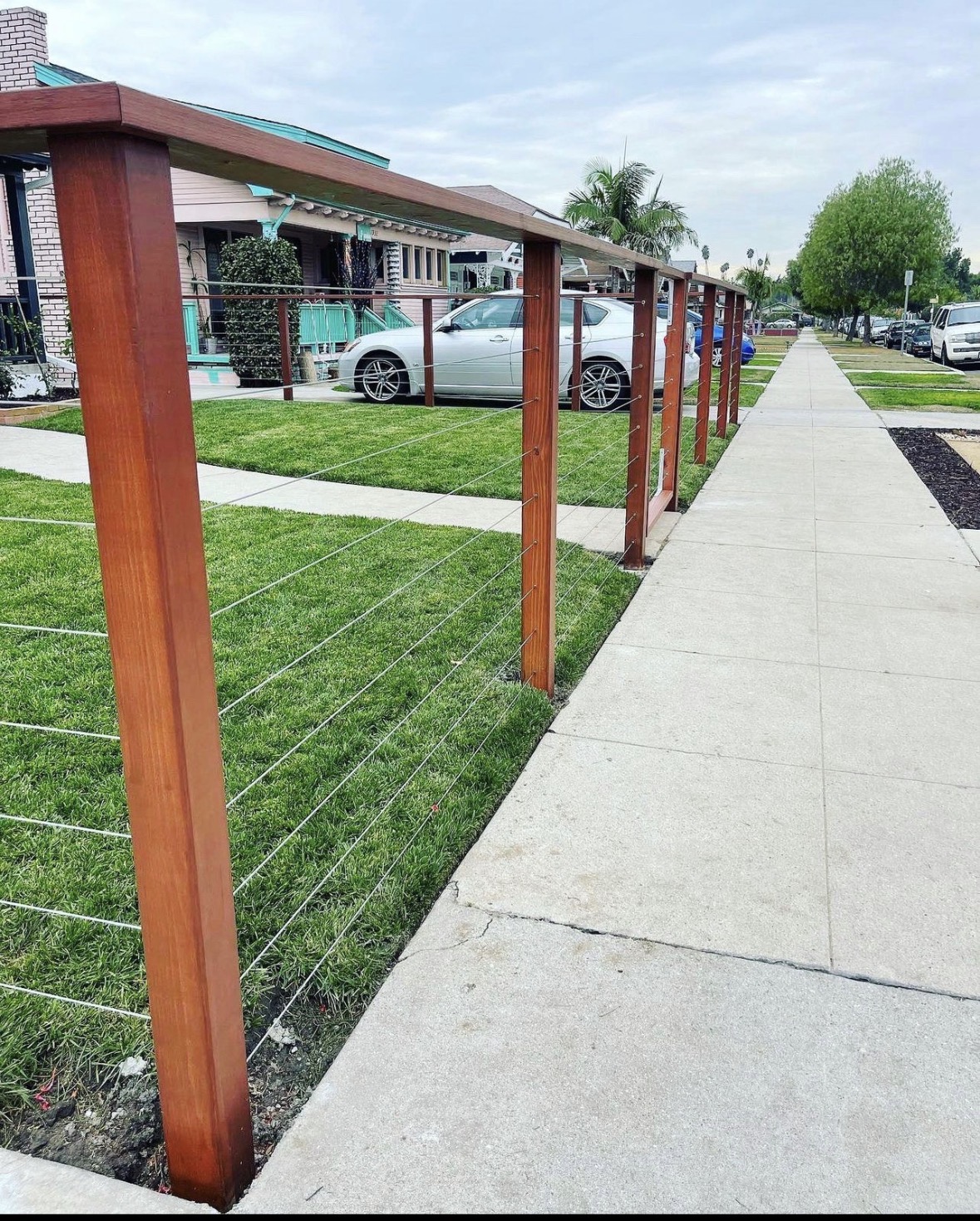 Cable wire railing along a residential sidewalk