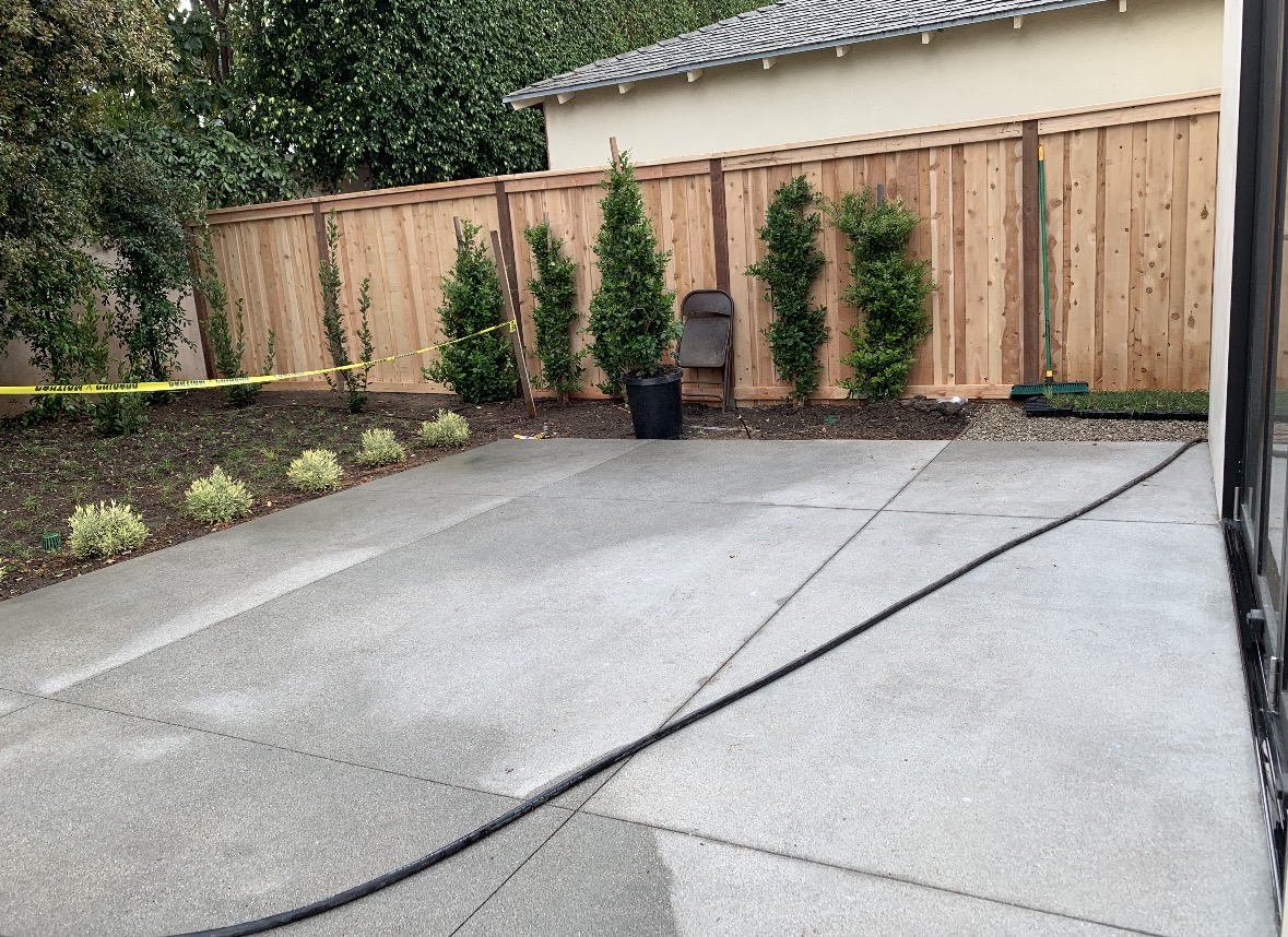 New wood fence alongside a landscaped patio