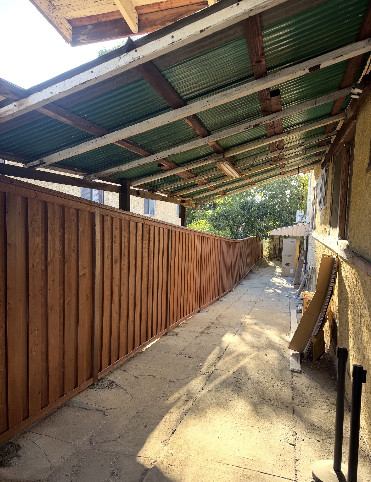 Long redwood fence along a covered walkway