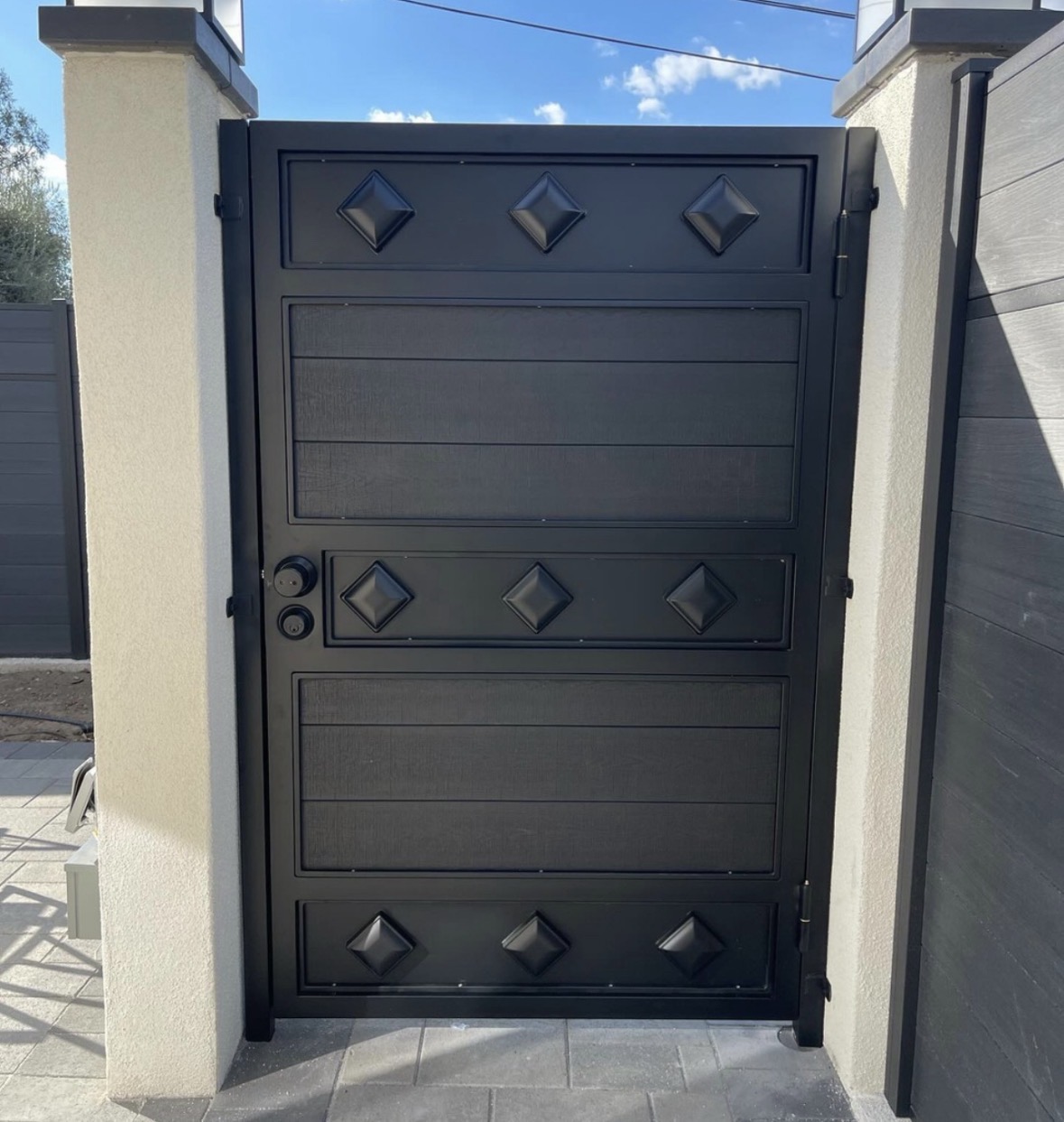 Black iron walk gate with matching square accents