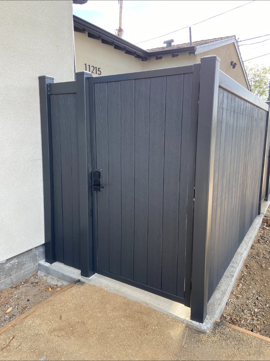 Dark vinyl walk gate in front of a home