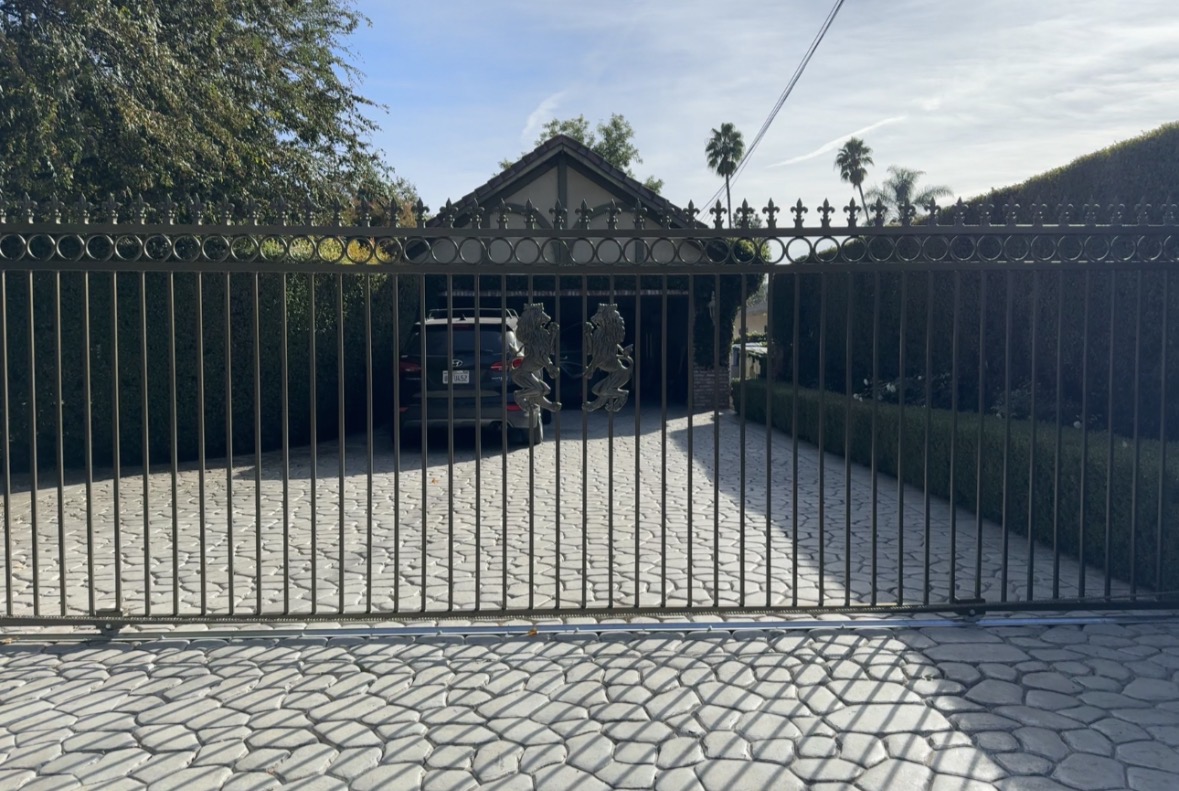 Wrought iron driveway gate with lion medallions