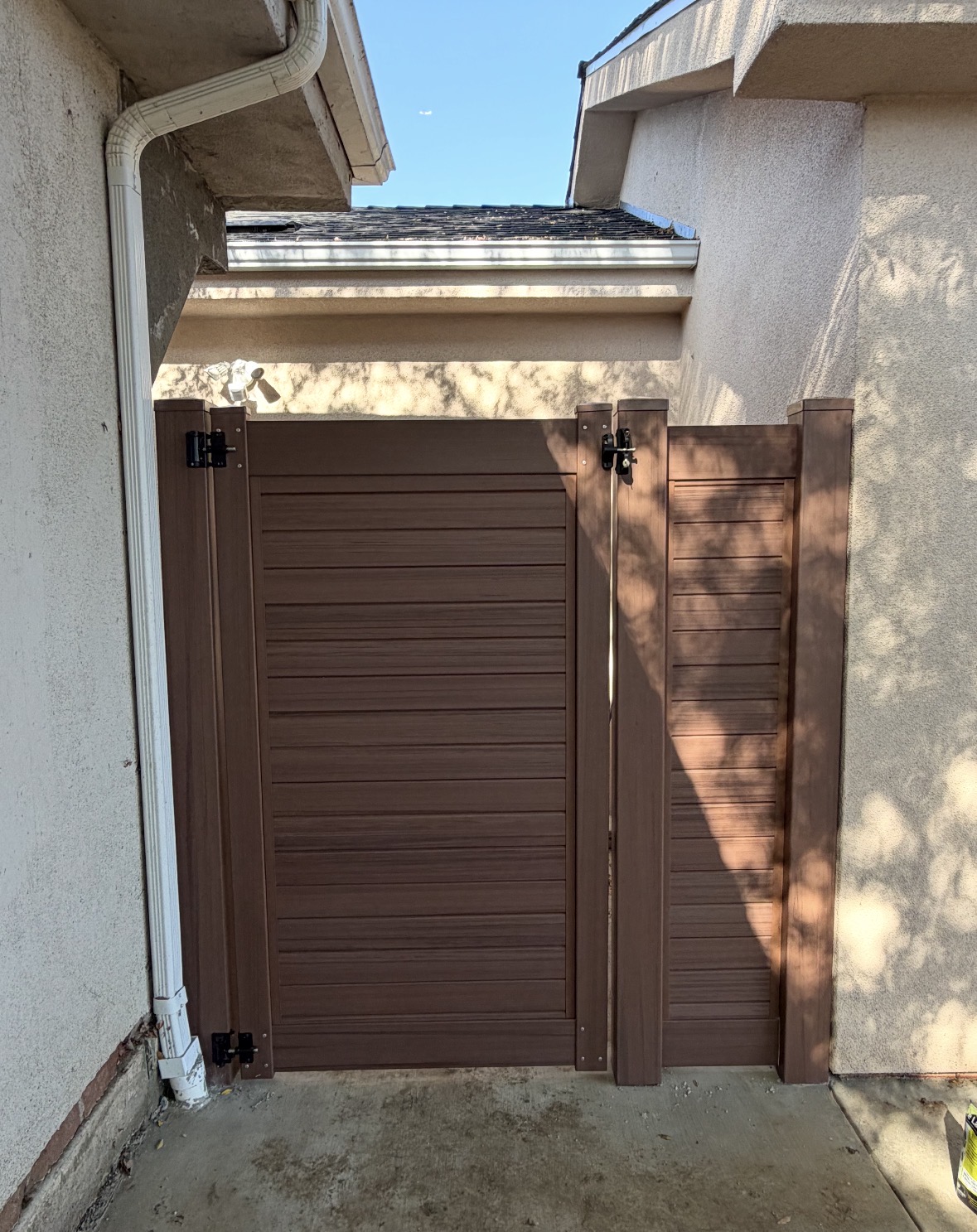 Brown vinyl double gate in a narrow entry