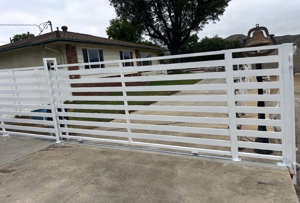 White slat sliding gate with matching fence panels